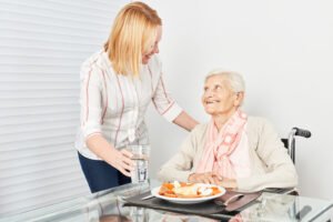 bigstock Nursing lady serves old woman 247971127